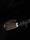 Professional microphone on a black background. Minimalism. Close-up. Recording studio, music studio, vocal, concert, night club,