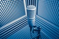 Professional microphone in sound recording studio, blue acoustic foam background Royalty Free Stock Photo