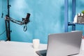 Professional microphone swivel boom arm stand in empty vlog broadcasting studio Royalty Free Stock Photo