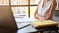 Professional millennial Asian businesswoman sits at her desk or meeting table with arms crossed Royalty Free Stock Photo