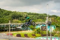 A professional motorcycle rider giving a free style motorcross acrobatics demonstration in Shenzhen Zoo park, in China