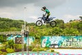 A professional motorcycle rider giving a free style motorcross acrobatics demonstration in Shenzhen Zoo park, in China