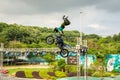 A professional motorcycle rider giving a free style motorcross acrobatics demonstration in Shenzhen Zoo park, in China