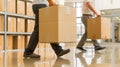 Professional movers carrying boxes during relocation or delivery into a home or office space. Efficient and coordinated Royalty Free Stock Photo