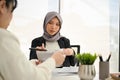 Professional Muslim female boss in the meeting with her team, discussing plan for new project Royalty Free Stock Photo