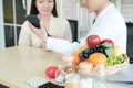 Professional nutritionist asian man consulting asia woman in clinic or hospital or medical club Royalty Free Stock Photo