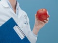 Professional nutritionist holding an apple