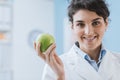 Professional nutritionist holding a fresh apple