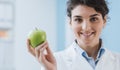 Professional nutritionist holding a fresh apple