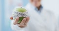 Professional nutritionist holding a fresh apple