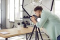 Professional object photographer working in his studio and taking photos of cactus on table Royalty Free Stock Photo