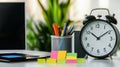 A professional office environment featuring a clock and vibrant sticky notes for time management Royalty Free Stock Photo