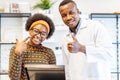 Professional ophthalmologist doctor african american man helping young woman african american client to choose a spectacles