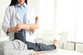 Professional orthopedist examining patient`s leg in clinic. Space for text Royalty Free Stock Photo