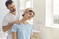 Professional osteopath during work fixing womans neck