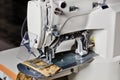 Professional overlock sewing machine, equipment for hemming and sewing clothes, close-up Royalty Free Stock Photo