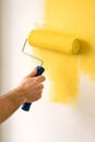 Professional Paint Roller Applying Bright Yellow Color For Creative Interior Wall Design Royalty Free Stock Photo