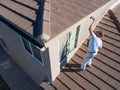 Professional Painter Using A Brush to Paint House Fascia