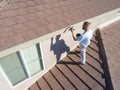 Professional Painter Using A Brush to Paint House Fascia