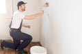 Professional painter worker is painting one wall Royalty Free Stock Photo