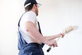 Professional painter worker is painting one wall Royalty Free Stock Photo