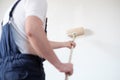 Professional painter worker is painting one wall Royalty Free Stock Photo