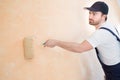 Professional painter worker is painting one wall Royalty Free Stock Photo