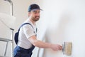 Professional painter worker is painting one wall Royalty Free Stock Photo