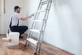 Professional painter worker is painting one wall Royalty Free Stock Photo