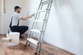 Professional painter worker is painting one wall