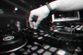 professional panel DJ mixer with hand controlling mixing music in nightclub