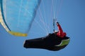 A professional paraglider against the blue sky