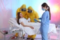 Professional paramedics examining patient with virus in ward
