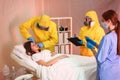 Professional paramedics examining patient with virus in ward