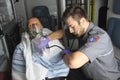 Professional paramedics giving unconscious men