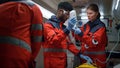 Professional paramedics performing first aid procedure in emergency car