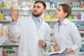 Professional pharmacists working together in drugstore