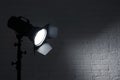 Professional photo studio lighting equipment near brick wall. Royalty Free Stock Photo