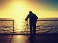 Professional photograph at sea. Tourist on wharf photograph