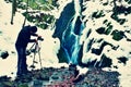 Professional photograph takes with camera on tripod photo of winter waterfall. Royalty Free Stock Photo