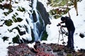 Professional photograph takes with camera on tripod photo of winter waterfall. Royalty Free Stock Photo