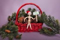 Happy December sign held by wooden jointed manikin doll wearing a red Santa Claus hat Royalty Free Stock Photo