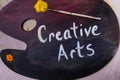 Creative Arts painted on wooden artist paint palette one paintbrushes Royalty Free Stock Photo