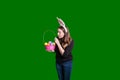 Young lady holding up and looking inside a holiday Easter egg basket wearing bunny ears Royalty Free Stock Photo