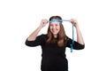 Young blonde female measuring head with blue rolling tape measuring