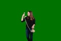 Young blond women yelling into old telephone reciever on green screen background Royalty Free Stock Photo