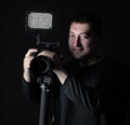 Professional photographer with camera on tripod.isolated on black background Royalty Free Stock Photo