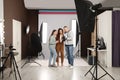 Professional photographer and makeup artist with model in studio Royalty Free Stock Photo