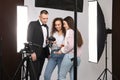 Professional photographer and makeup artist with model in studio Royalty Free Stock Photo