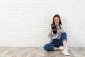 Professional photographer with modern camera near white brick wall Royalty Free Stock Photo